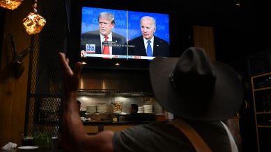 TV-Duell Donald Trump und Joe Biden – Mann mit Cowboy-Hut betrachtet Fernseher in einem Restaurant, San Carlos, Kalifornien; © picture alliance/Anadolu/Tayfun Coskun