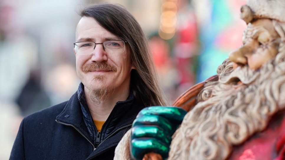 Christian Fein, Initiator des Projektes "KeinerBleibtAllein" neben einer Weihnachtsmannfigur; © picture alliance/dpa/Uwe Anspach